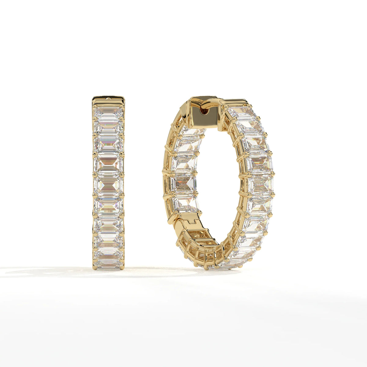 A pair of gold hoop earrings set with large rectangular clear gemstones, shown on a clean white background. One earring is displayed upright and the other is angled to show the side and back details.