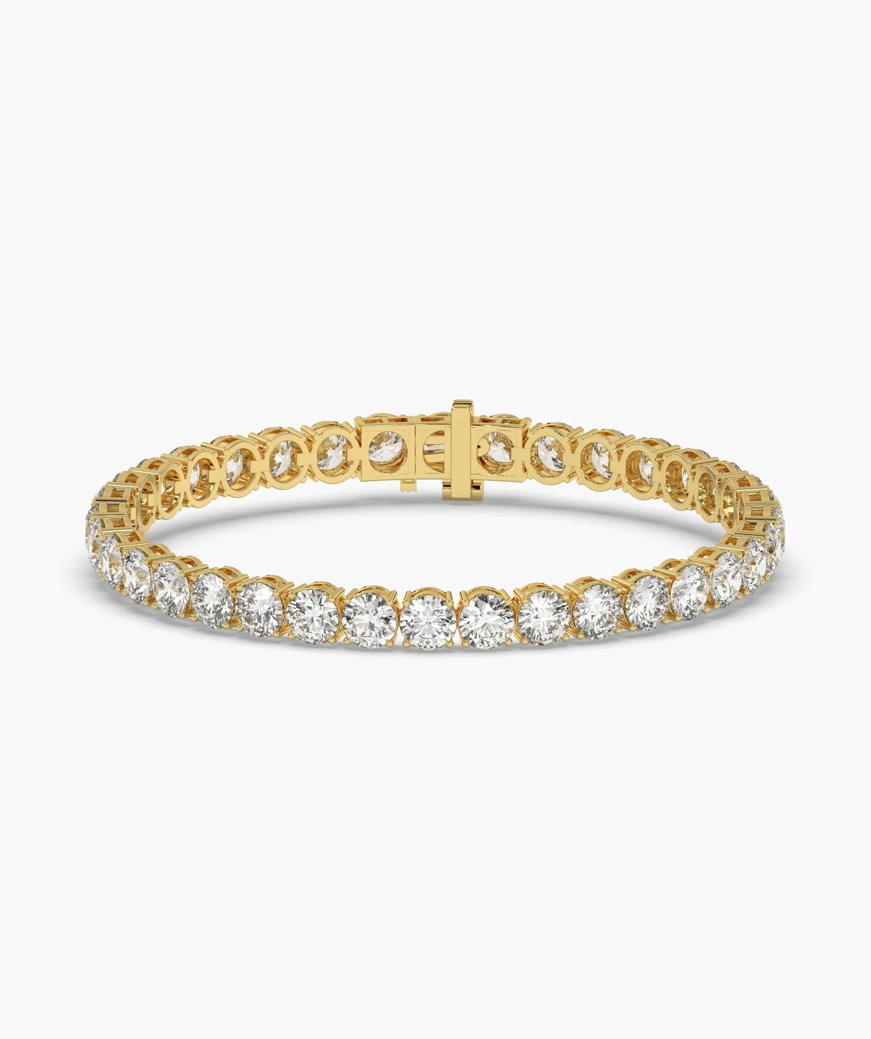 A yellow gold tennis bracelet featuring a continuous row of round-cut clear gemstones in a prong setting, with a matching gold clasp, shown on a white background.