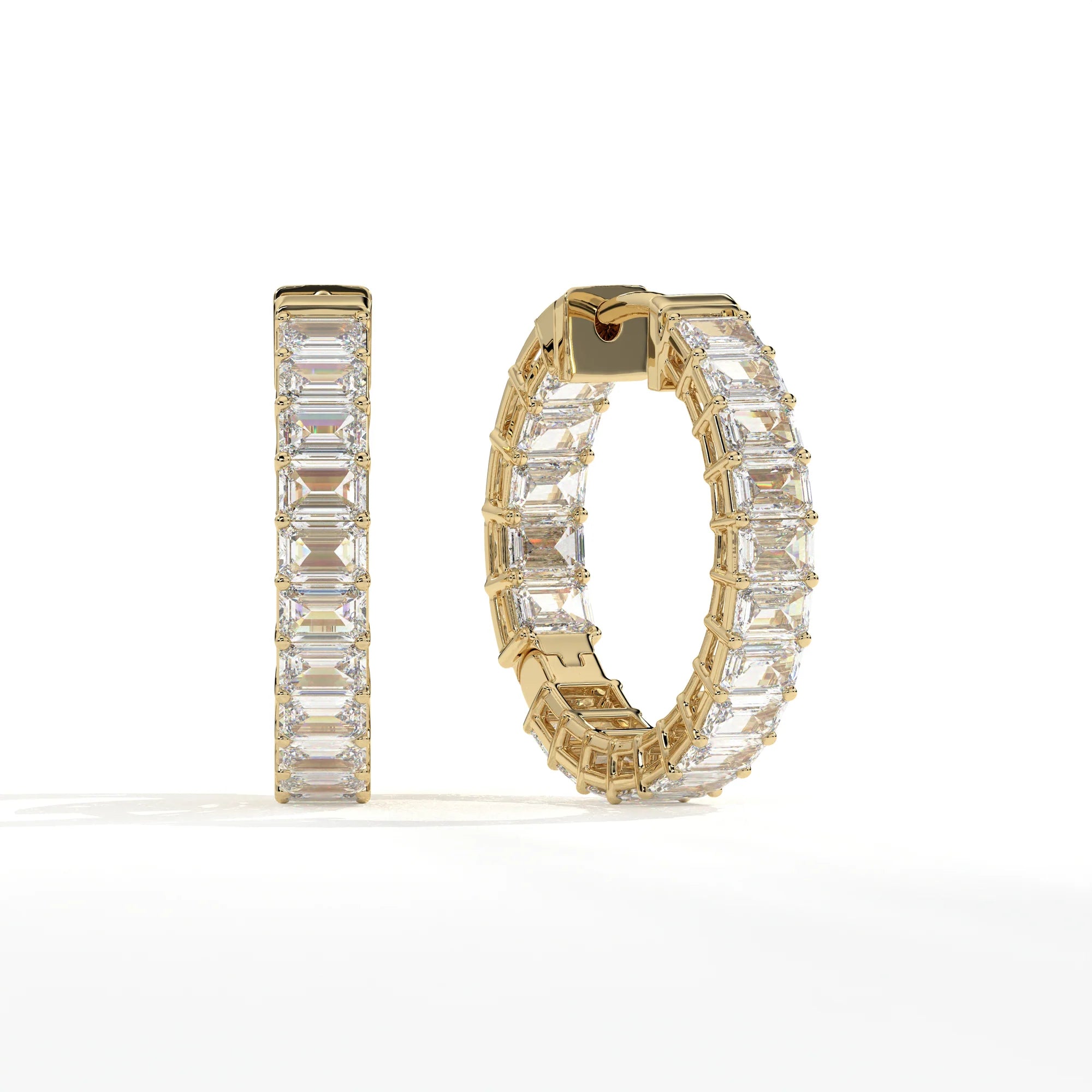 A pair of gold hoop earrings set with large rectangular clear gemstones, shown on a clean white background. One earring is displayed upright and the other is angled to show the side and back details.