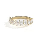 A yellow gold diamond ring featuring a row of pear-cut diamonds set in a curved band, photographed on a clean white background with a soft shadow.