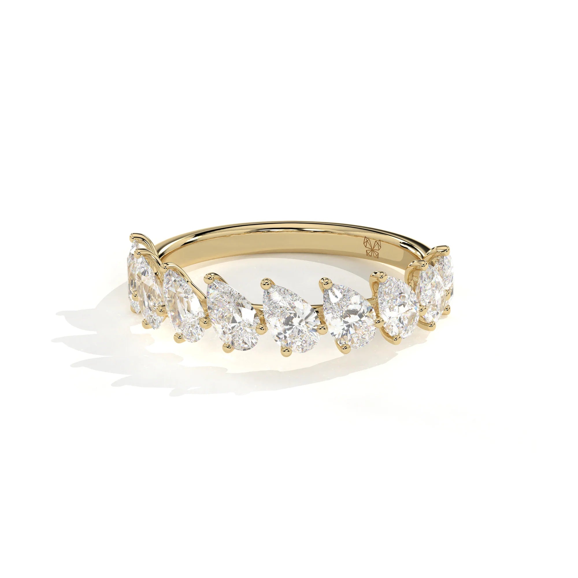 A yellow gold diamond ring featuring a row of pear-cut diamonds set in a curved band, photographed on a clean white background with a soft shadow.