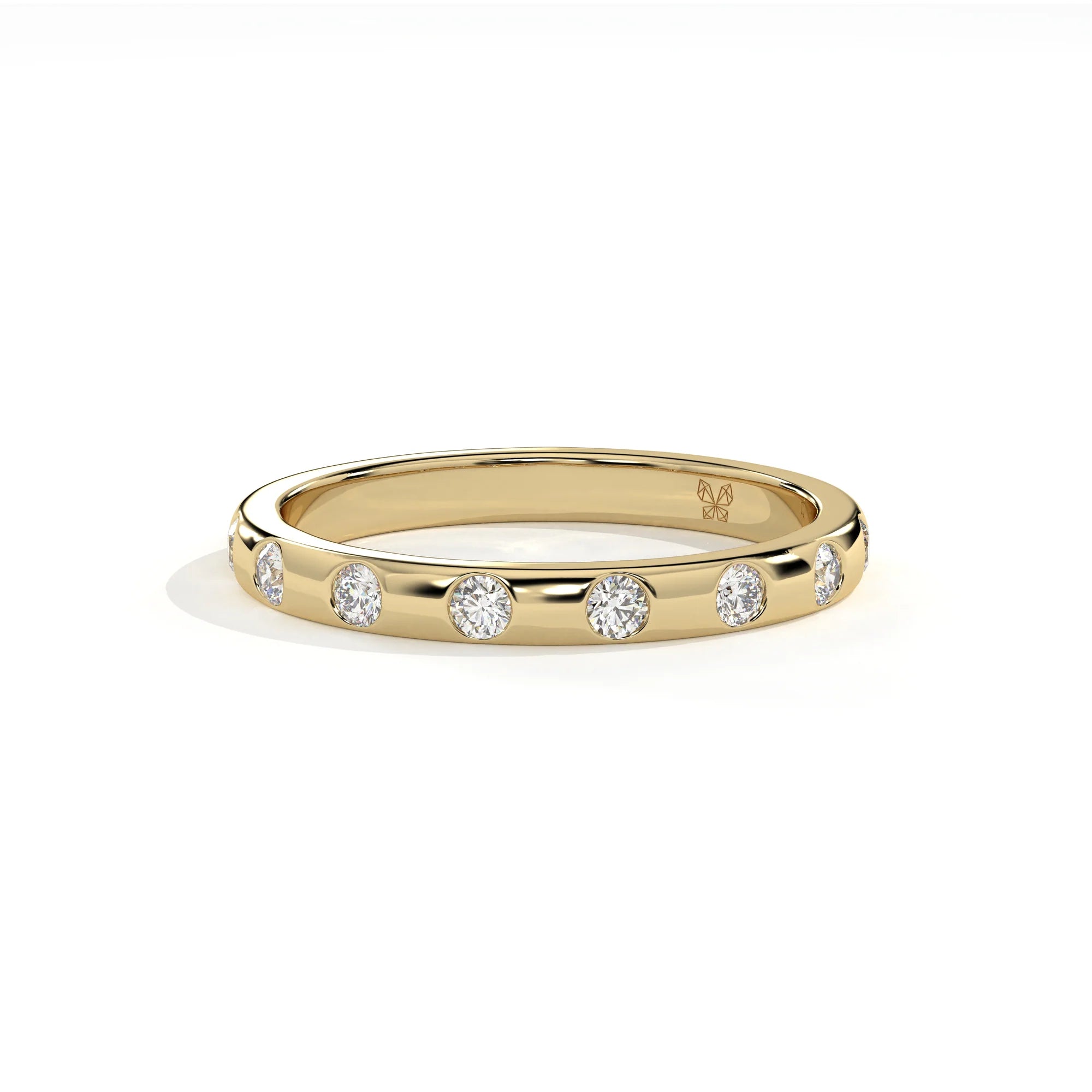 A yellow gold eternity ring featuring a row of round-cut clear gemstones, photographed on a clean white background with a soft shadow.