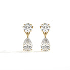 A pair of gold drop earrings featuring a round brilliant-cut diamond stud on the top and a larger pear-cut diamond drop below, set against a clean white background.