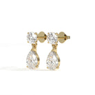 Gold earrings with clear gemstones on a white background