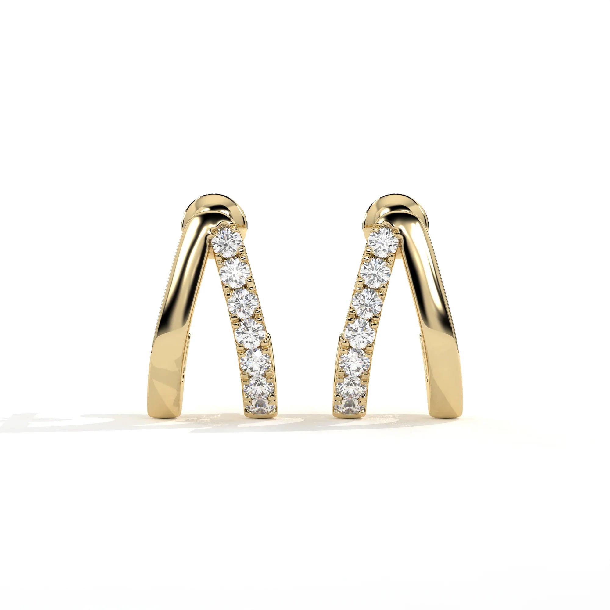 A pair of gold huggie earrings with a channel-set row of clear round diamonds, photographed on a clean white background.