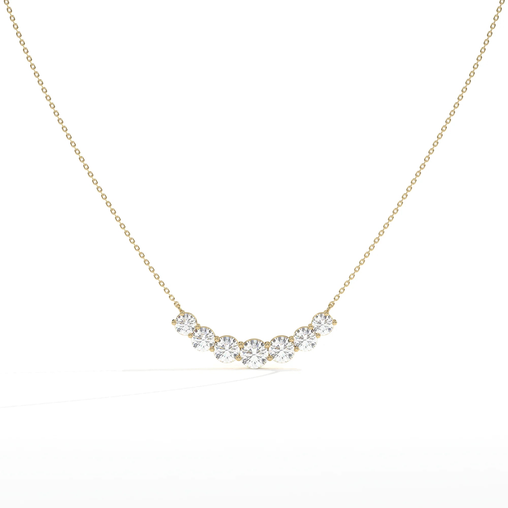 A delicate gold chain necklace featuring a curved row of five clear round-cut gemstones in a gold setting, displayed against a clean white background.